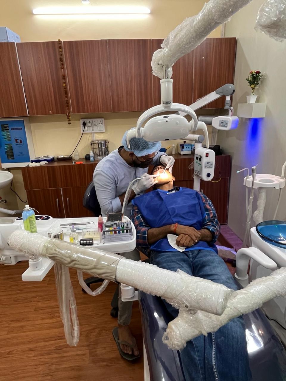 Dentist treating patient at T.P. Polyclinic & Dental Hospital